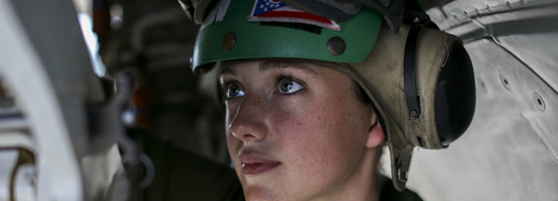 Female marine performs routine maintenance on an aircraft.