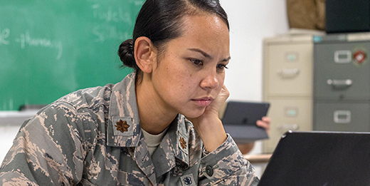 Service member works on her laptop