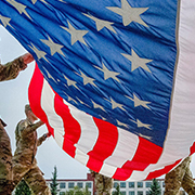 Service members folding flag