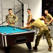 Service members playing pool.