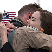 Service member hugging spouse