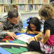 Service member learns with children in classroom.