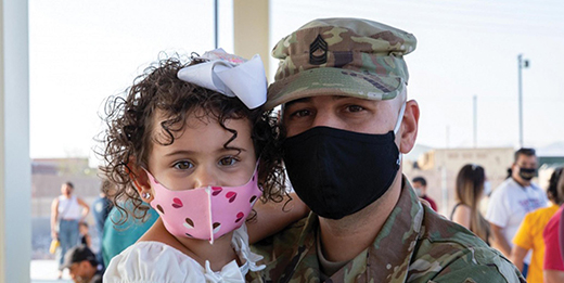 Service member and daughter wearing masks