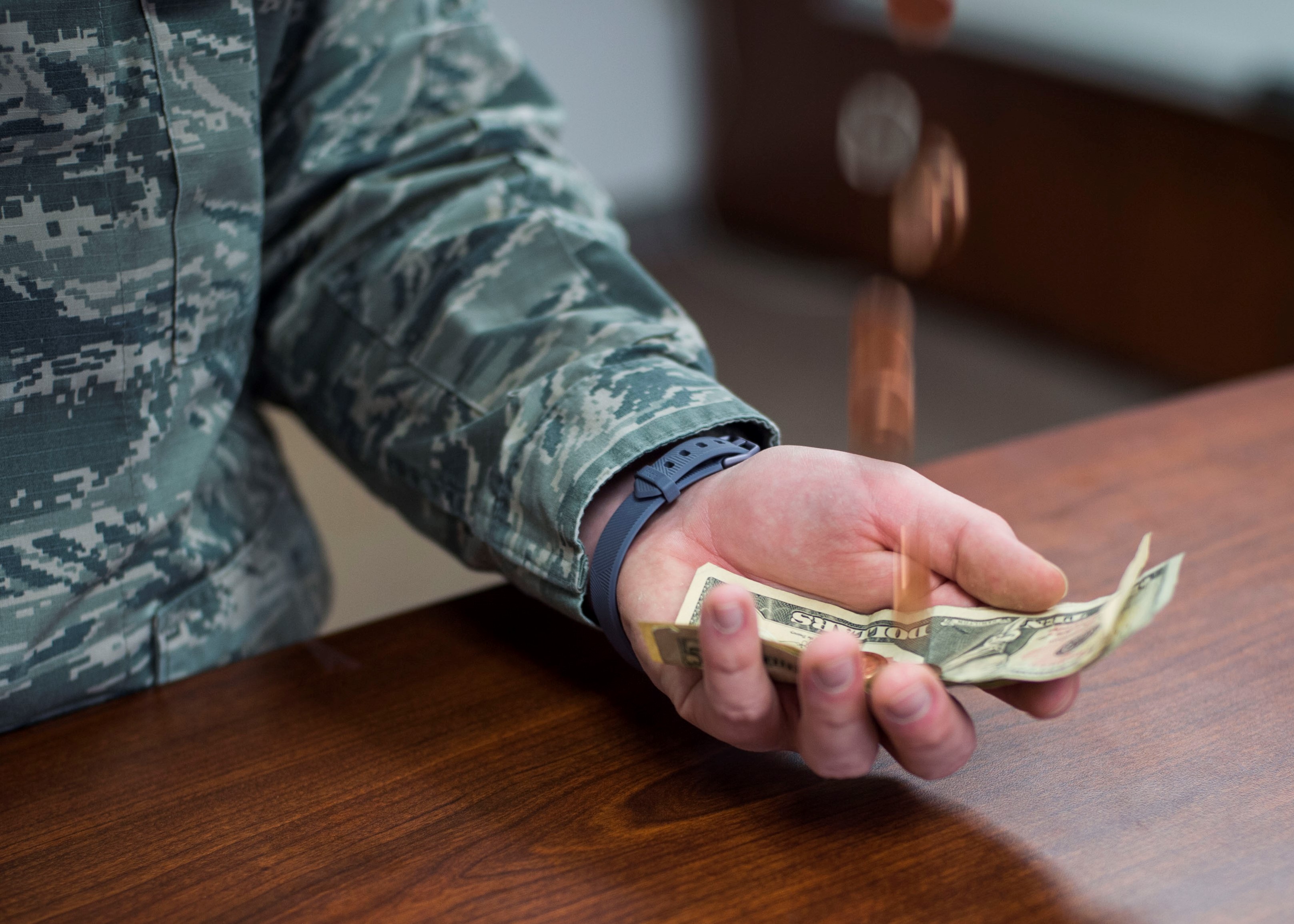 A service member holds money