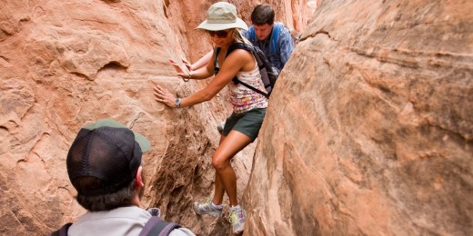 Hikers climb through rocks at U.S. National Park.