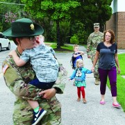Service members drop off their children at school. 