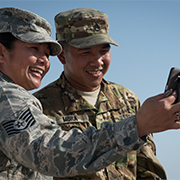 Service members take a photograph.