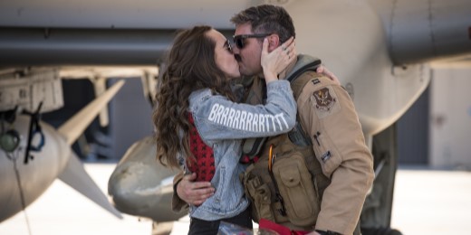 Spouse kissing a service member