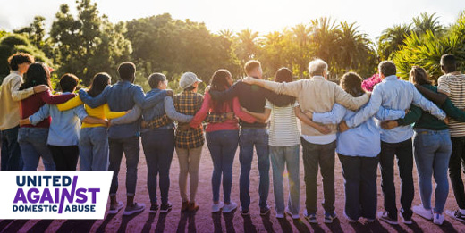 Group of people hugging one another