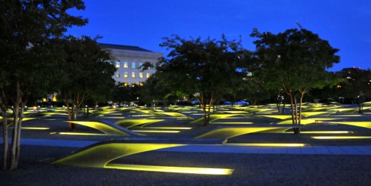 Lights begin to illuminate the National 9/11 Pentagon Memorial as the sun sets.
