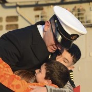 Service member hugs his children before deployment.