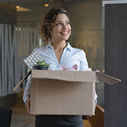Businesswoman moving into a new office with a box of belongings