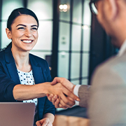 Businesswoman shaking hand with coworker