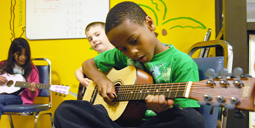 Child playing guitar