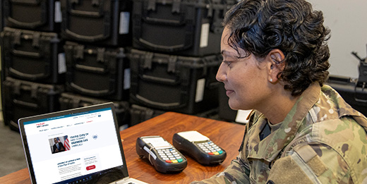 A service member uses a laptop