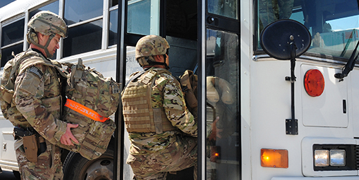 Soldiers getting on bus.