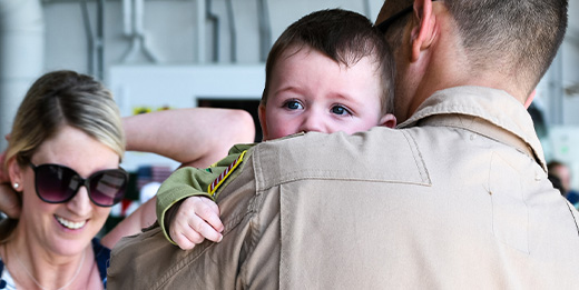 Father with baby looking over shoulder