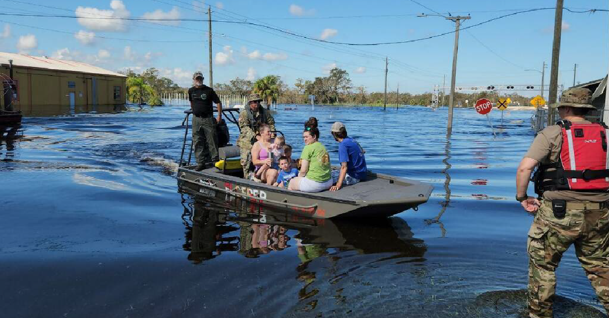 Family being boated to safety in flood