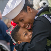 Military parent hugging child