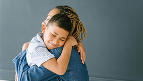 Parent and child hugging