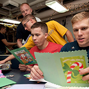 Service members celebrating and reading cards