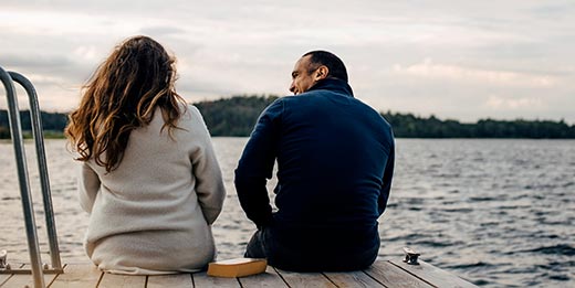 Couple talking on dock