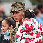 Military couple walking with child