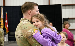 service member greeting child