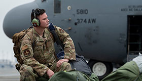 service member waits to board plane