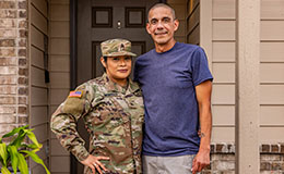 service member stands with husband