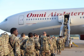 Service members boarding plane