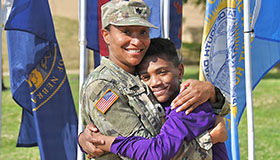 Service member embraces son