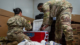 Service members pack a cooler