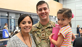 Service member smiling with family