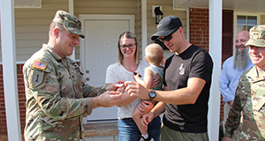 Family receives key to new home on base