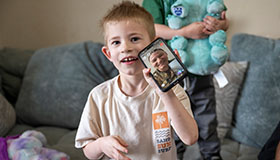 Child on video call with service member