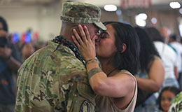 Service member and loved one kiss
