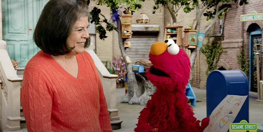 Patricia Montes Barron, deputy assistant secretary of defense for Military Community and Family Policy, talks with Elmo.