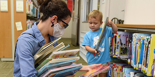 Woman with child in library