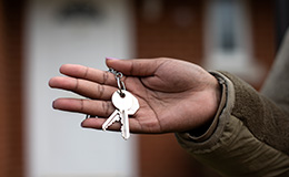 Service member holding house key