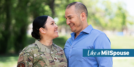 Service member and her spouse smiling at each other