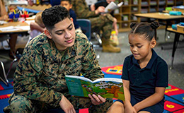 Service member reading to child.