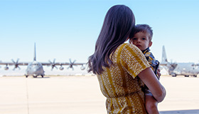 Spouse and child waiting on tarmac