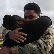 service member embracing family member