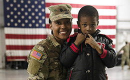 Service member posing with child