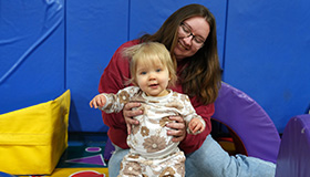 A mother plays with her baby