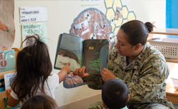 Service member reading book to child