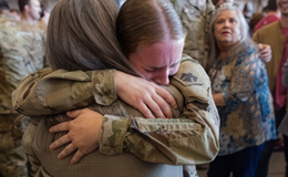 service member hugging family during reunion or deployment