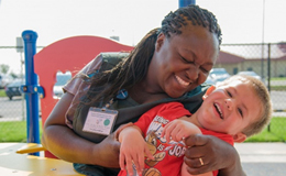 Caregiver and child smiling