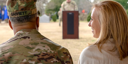 Service member and partner talking and smiling